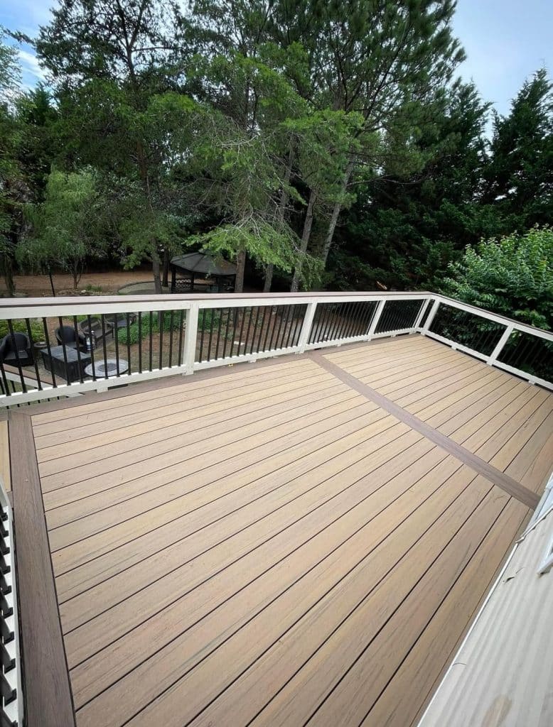 light and slightly darker brown wooden deck, white railing